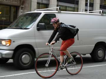 bicycle law activist Stacie Bain riding in downtown Seatle traffic.